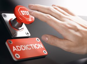 Woman pressing a panic button with stop sign to overcome addiction or dependence problems. Psychology concept.